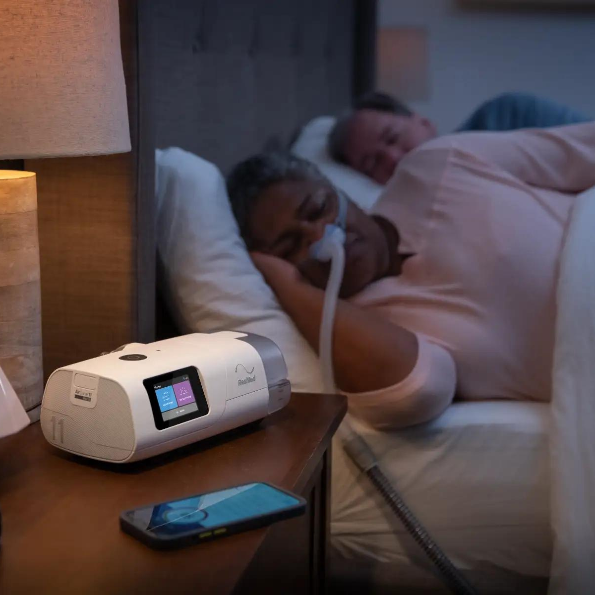 the resmed aircurve 11 asv machine on nightstand, in use